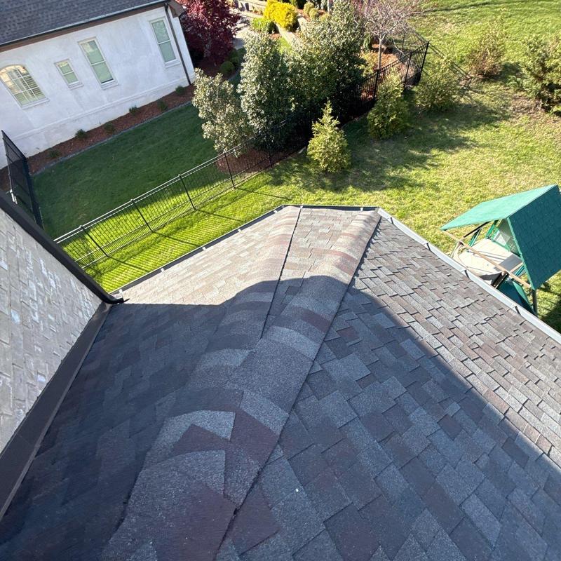Roof ridge shingles with hail damage and flashing