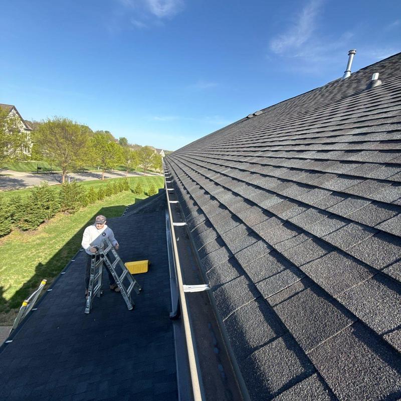 Asphalt shingle roof and gutter inspection with ladder