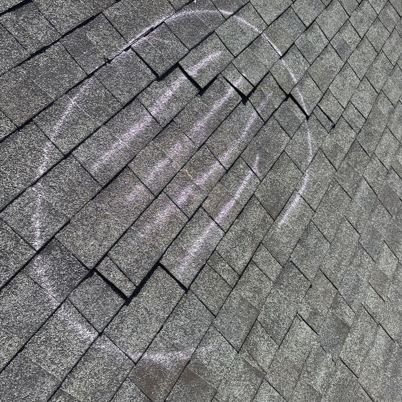 Asphalt shingle roof with hail damage markings