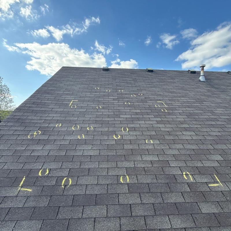 Asphalt shingles roof with yellow hail damage markings