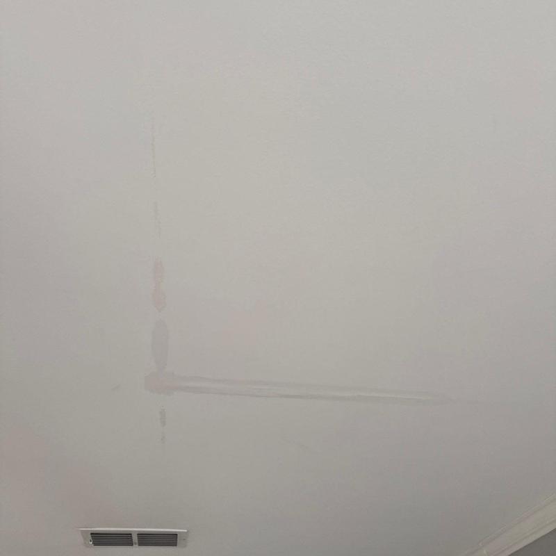 Ceiling drywall with water stain and damage marks