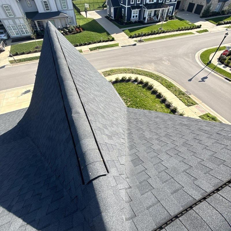 Asphalt shingle roof with ridge cap and ventilation