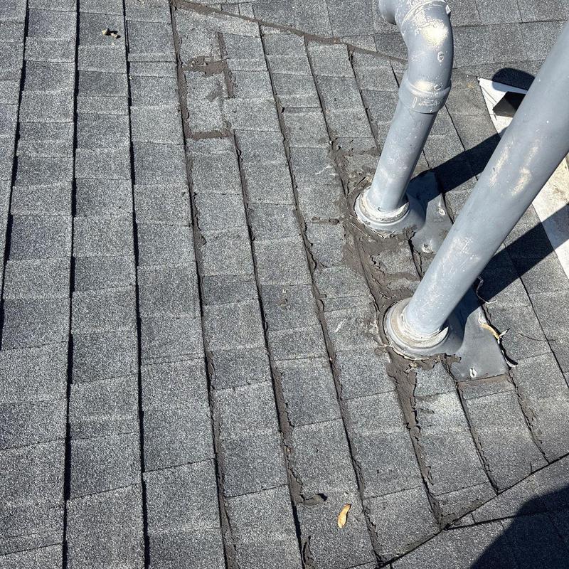 Roof shingles and pipe flashing with sealant wear