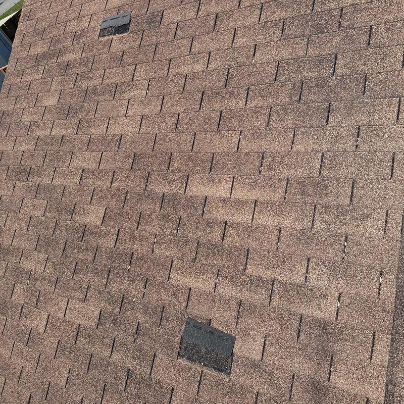 Asphalt shingle roof with hail damage and patch repair