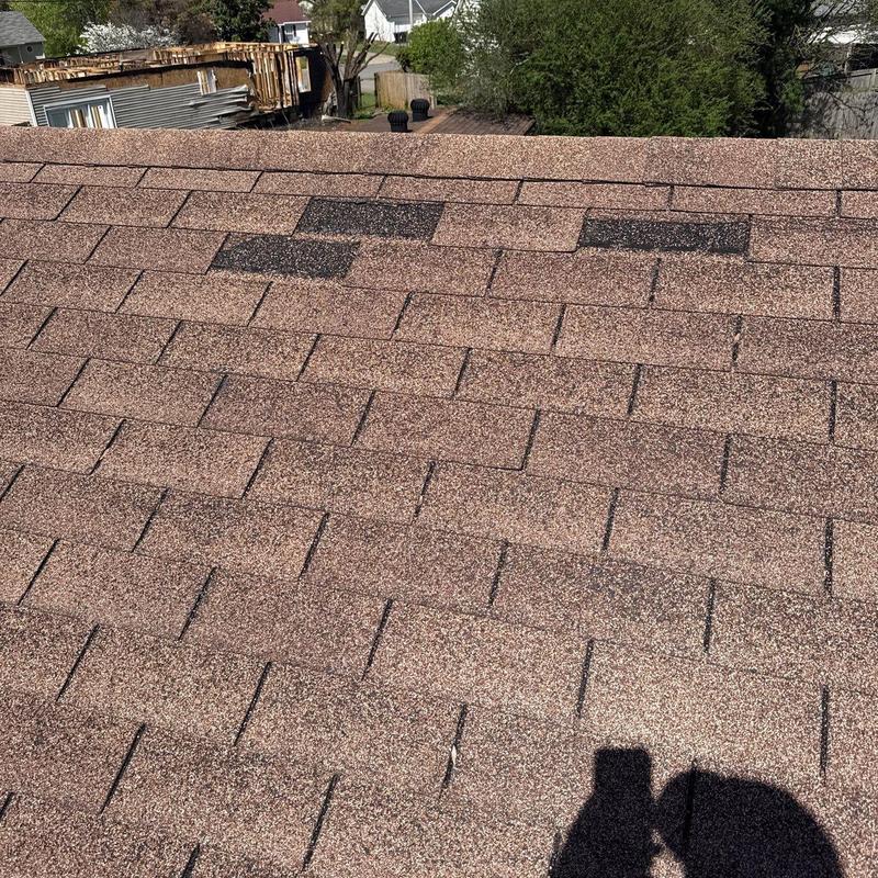 Asphalt shingle roof with hail damage spots