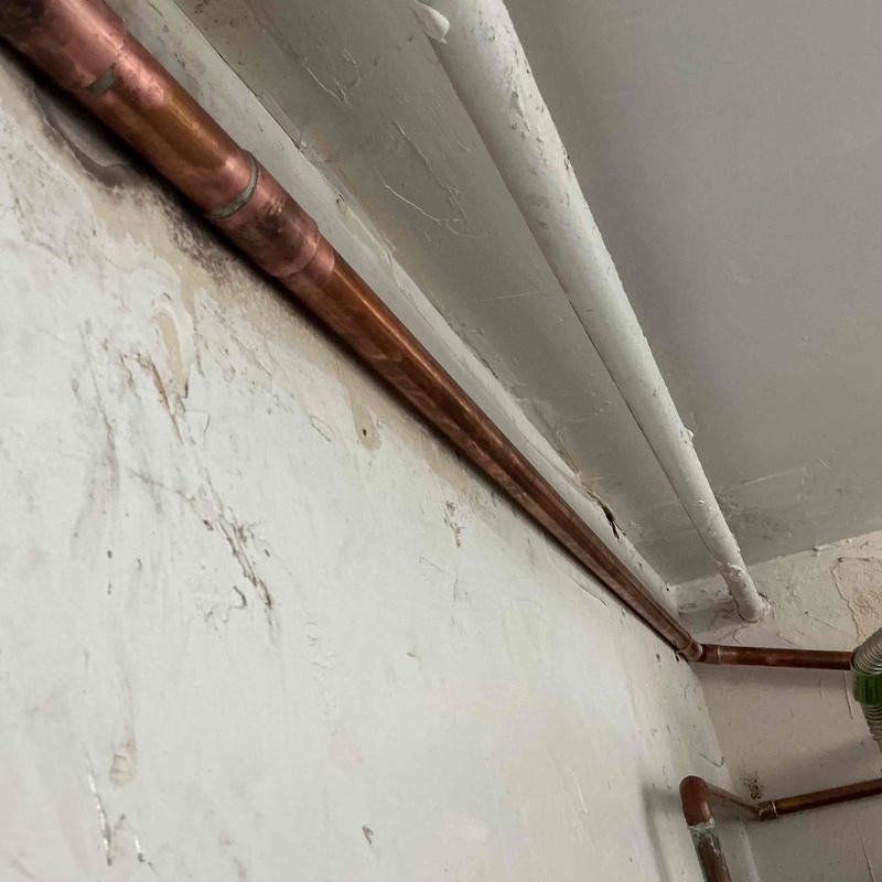 Copper water line replacement along ceiling wall