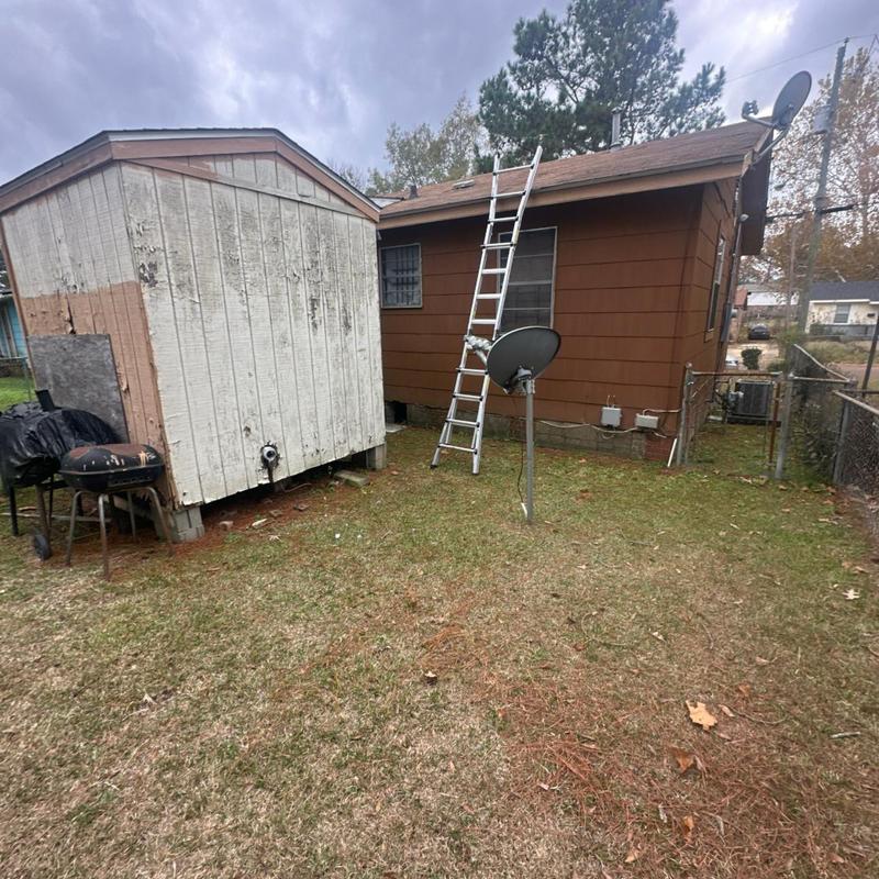 Roof shingles inspection with ladder on brown house
