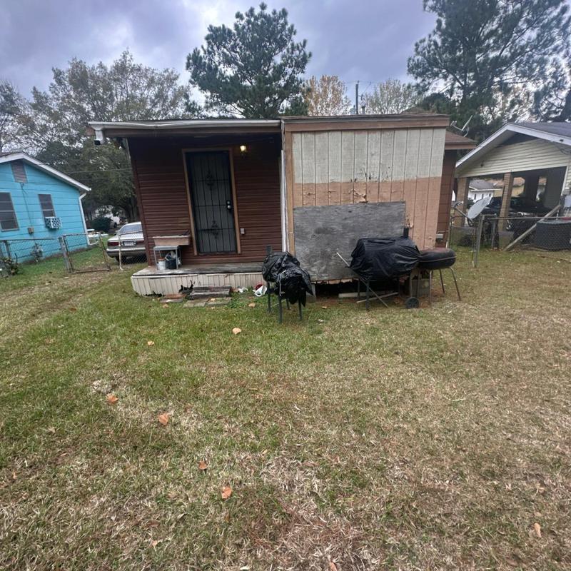 Siding panel on small house with backyard grill