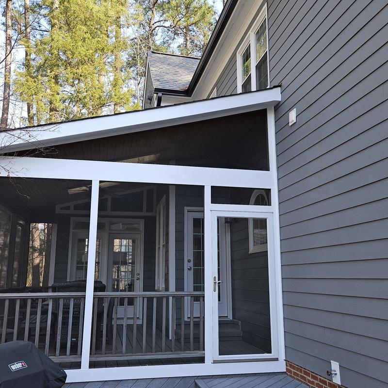 Screened porch enclosure with white trim and gray siding