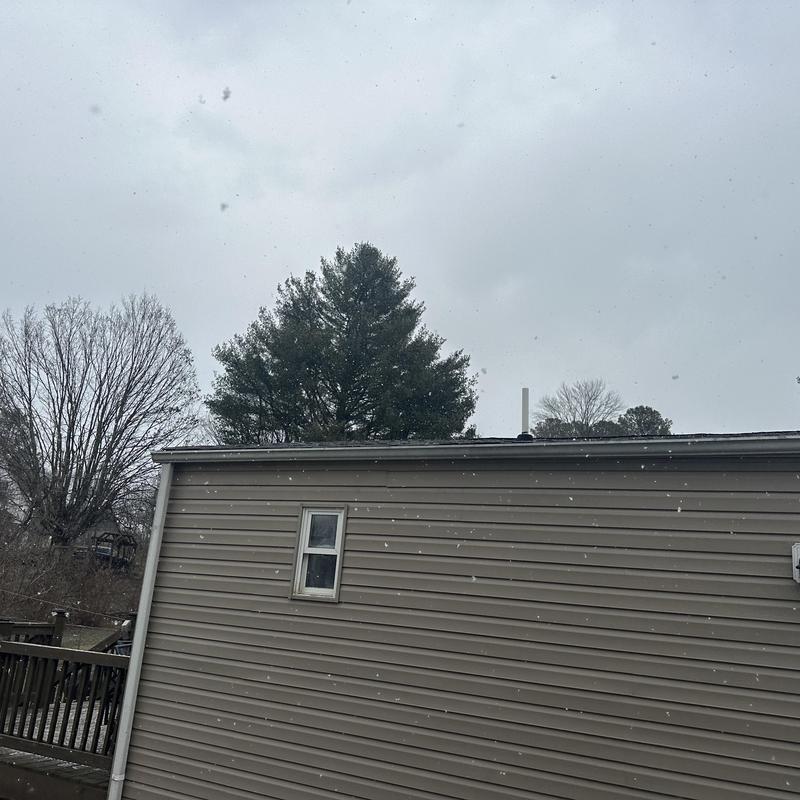 Shingle roof replacement on residential home in snow