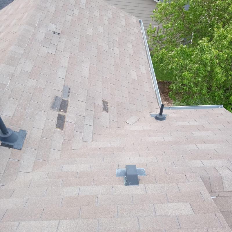 Shingle roof with minor wind damage and vents Shingle roof with minor wind damage and vents
