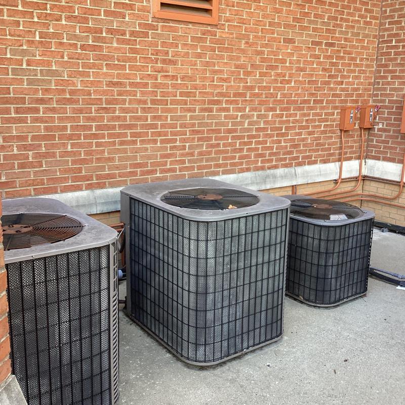 Commercial HVAC outdoor condenser units on concrete pad Commercial HVAC outdoor condenser units on concrete pad