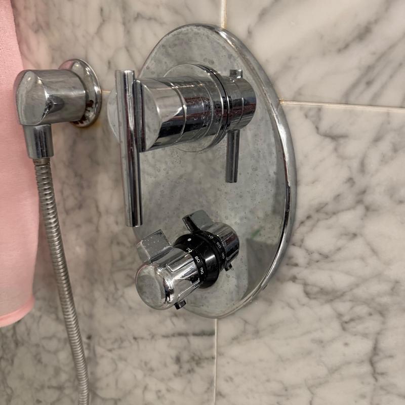Shower valve and temperature control assembly on marble wall