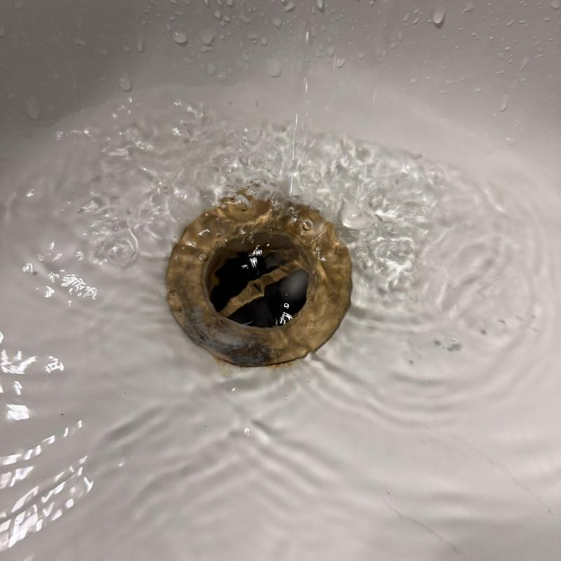 Bathtub drain flowing water after clog removal