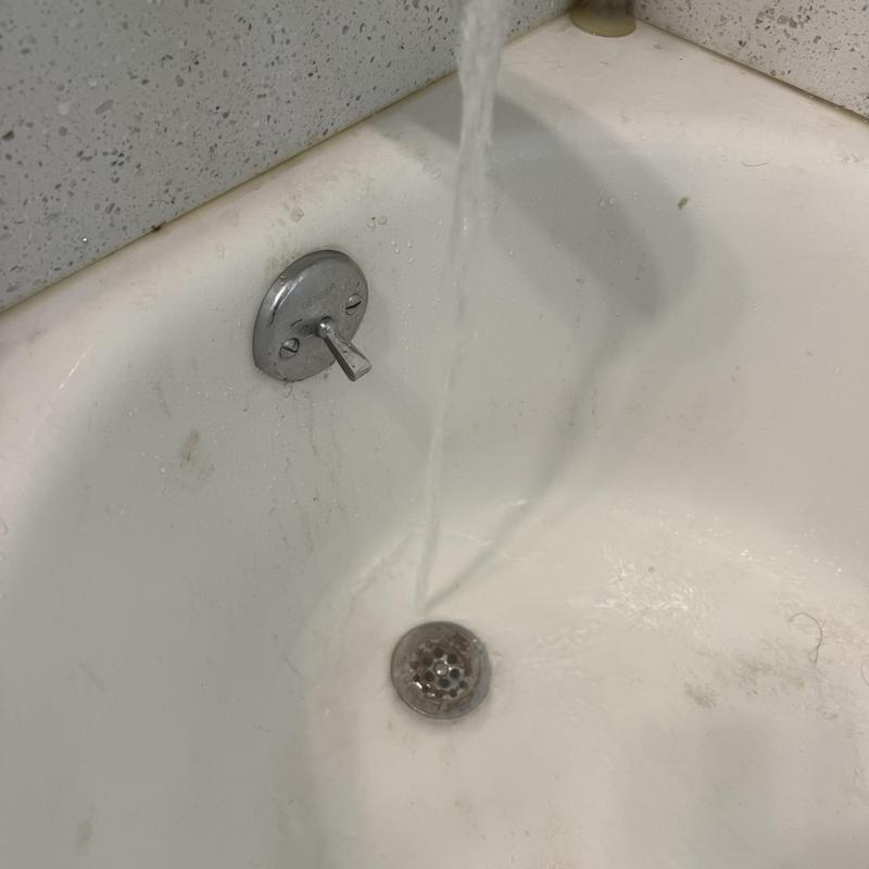 Bathtub drain with running water testing flow restoration