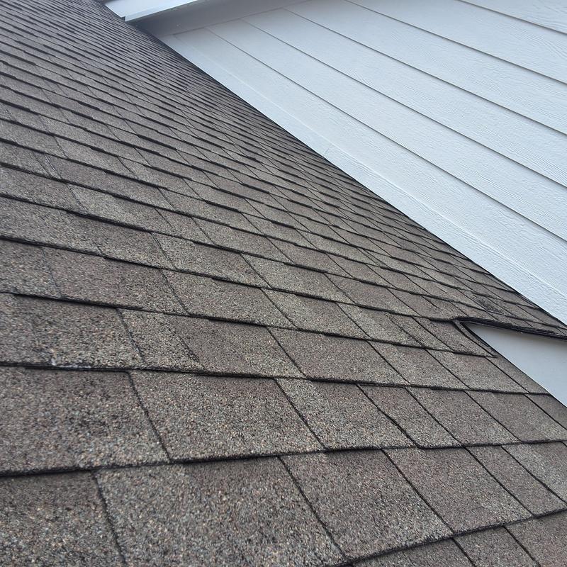 Asphalt shingle roof with granule loss and aging signs
