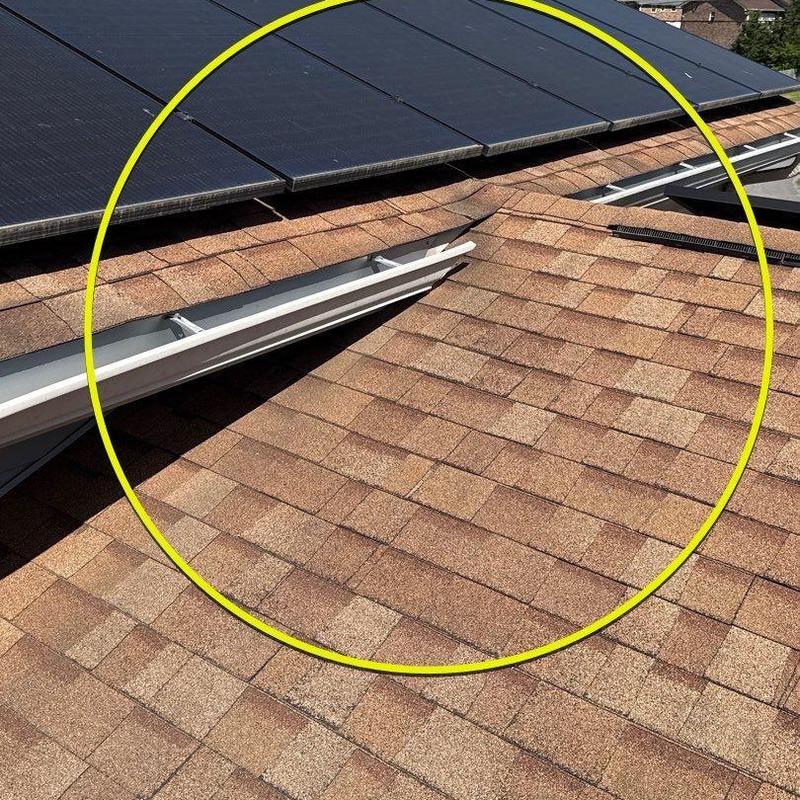 Asphalt shingles with hail damage near solar panels