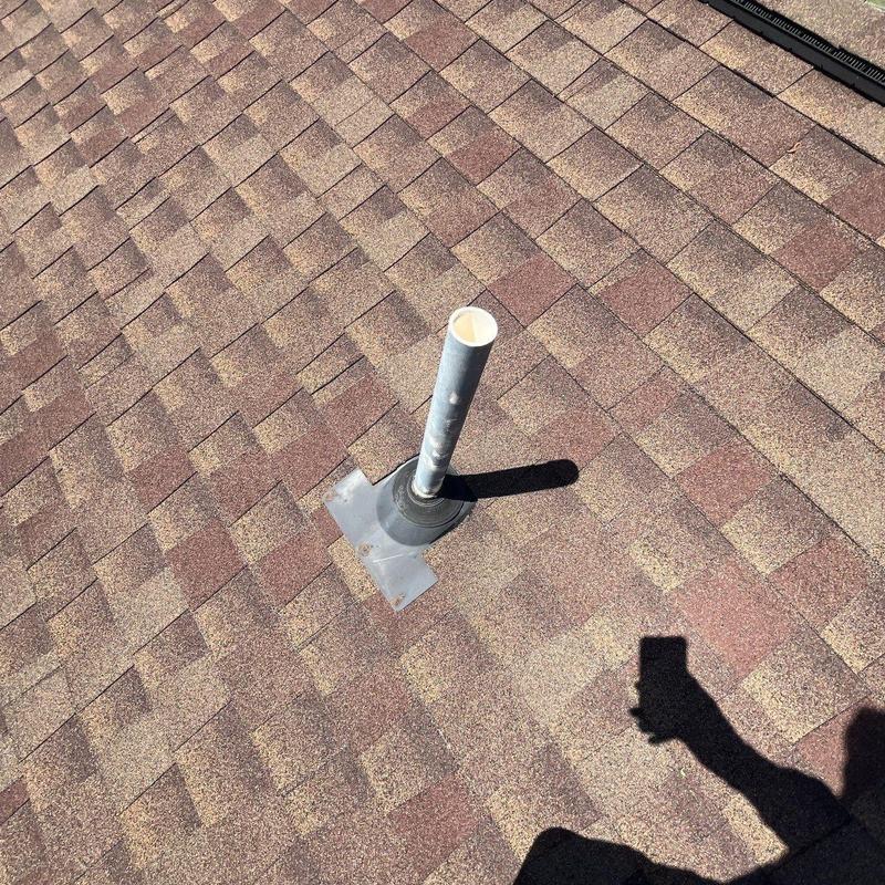 Roof vent pipe with flashing on shingle roof