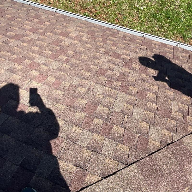 Asphalt shingle roof with hail damage and inspection shadows