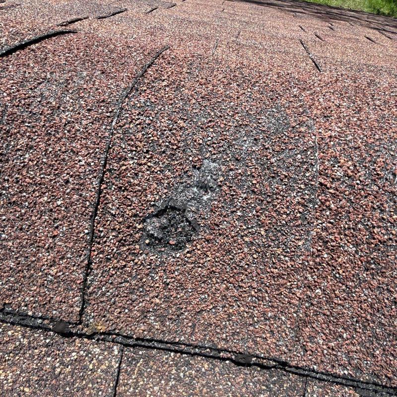 Asphalt shingle roof with hail damage and cracking