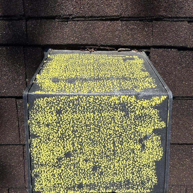 Roof vent with hail damage marking on asphalt shingles