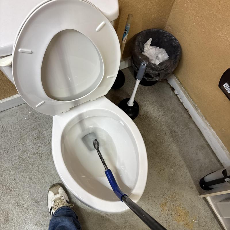 Toilet snaking tool clearing slow drain clog