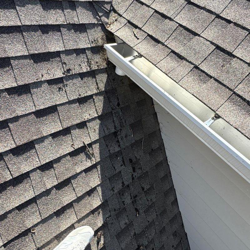 Asphalt shingle roof with hail damage and gutter system