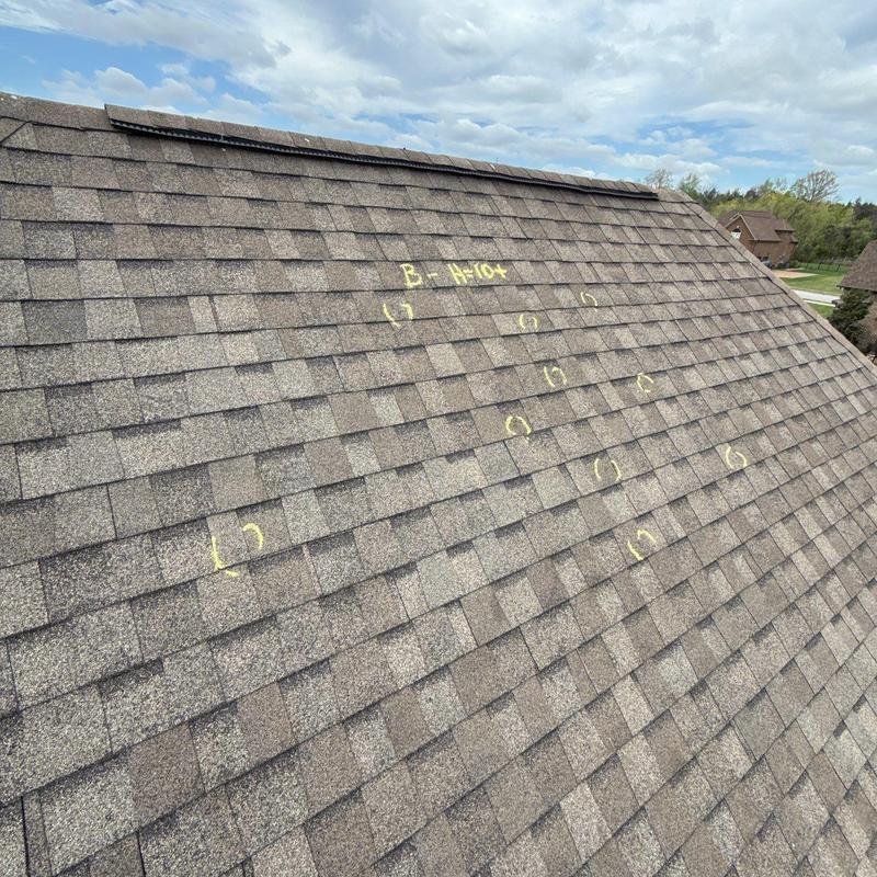 Asphalt shingle roof with hail damage markings