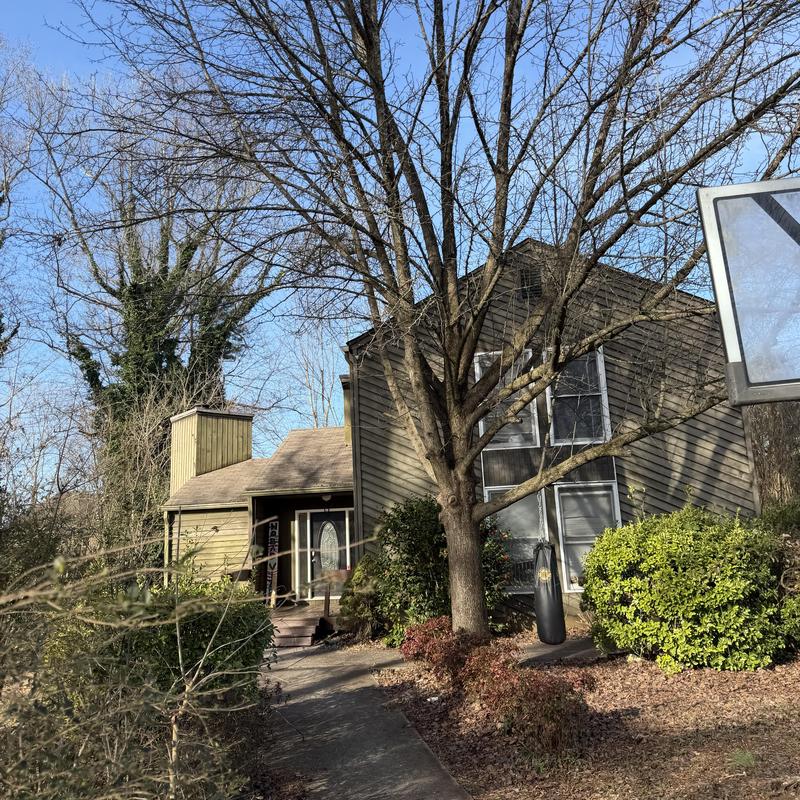 Green 6-inch gutter and downspout on two-story house