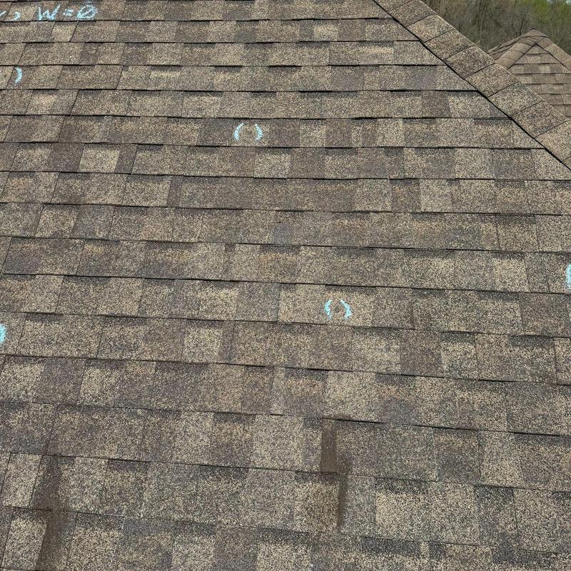 Asphalt shingle roof with hail damage markings