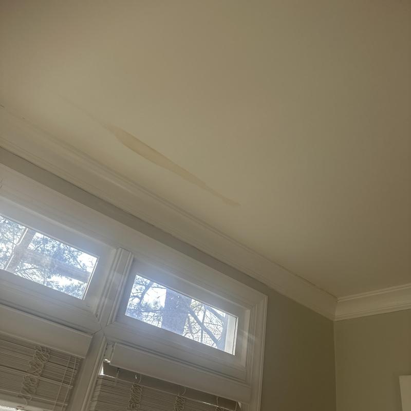 Drywall water stain on ceiling near window trim