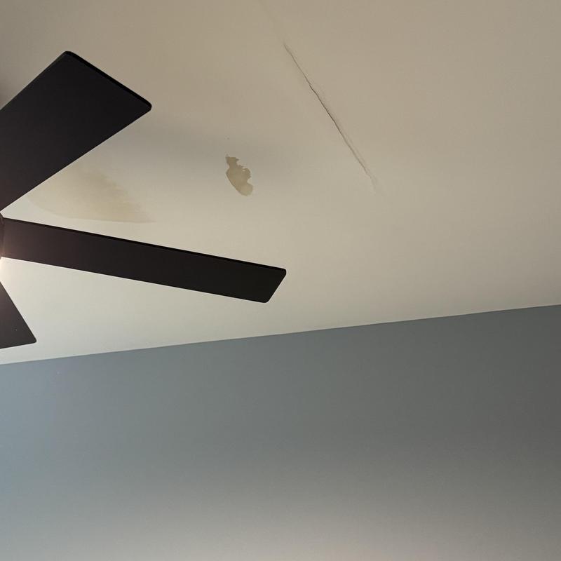 Ceiling drywall with water stains and crack