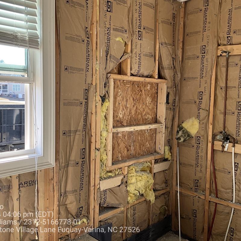 Wall insulation installation with exposed framing and window Wall insulation installation with exposed framing and window