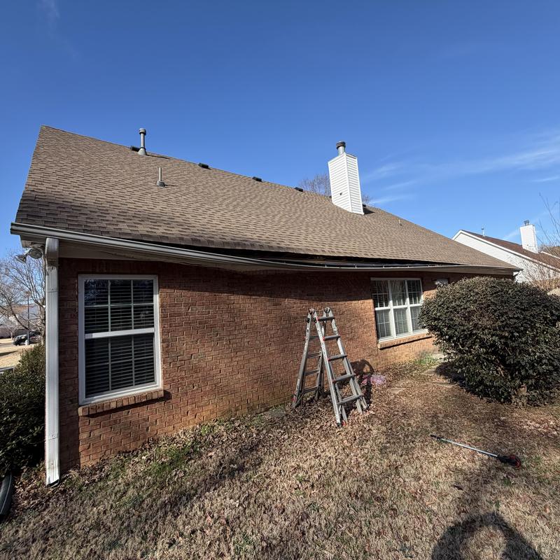 White 5-inch gutter pulled from roof edge near ladder