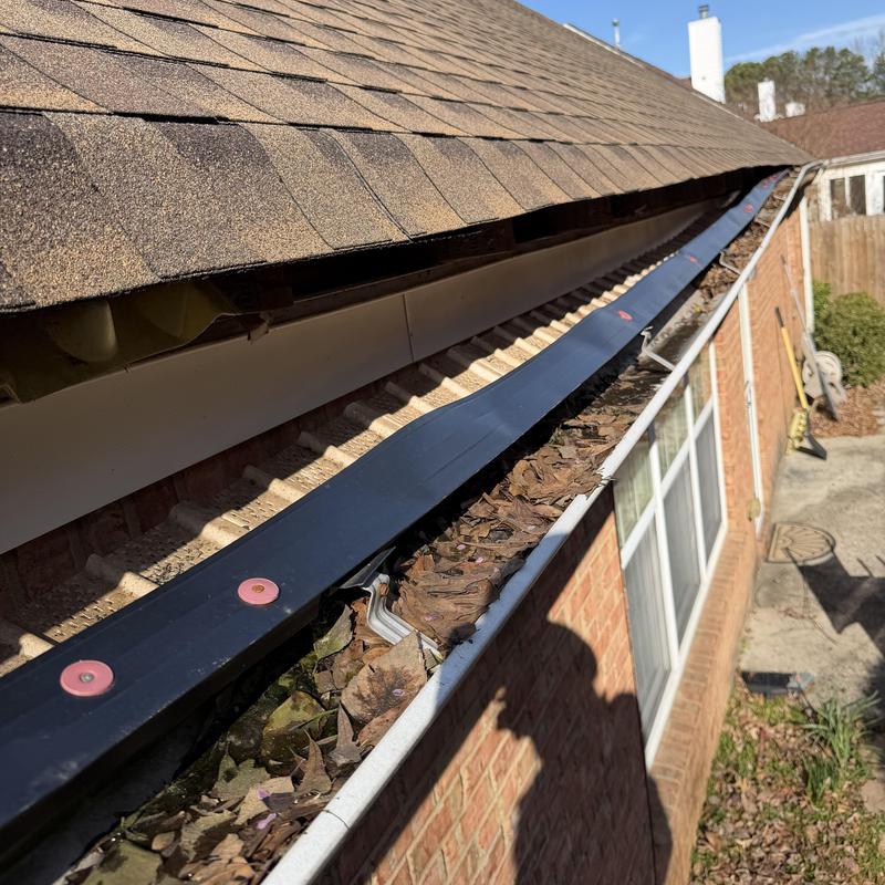 Drip edge installation over clogged gutter on shingle roof