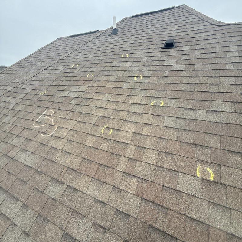 Asphalt shingles roof with hail damage marked
