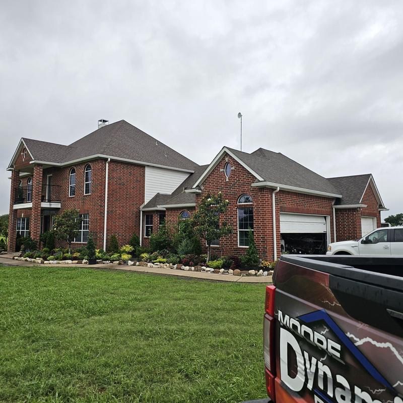 Asphalt shingle roof on brick house after hail storm