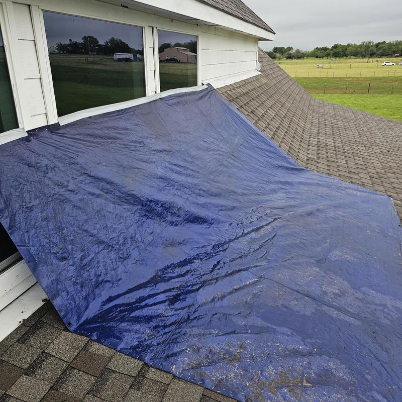 Roof tarp covering damaged shingles after hailstorm in Terrell
