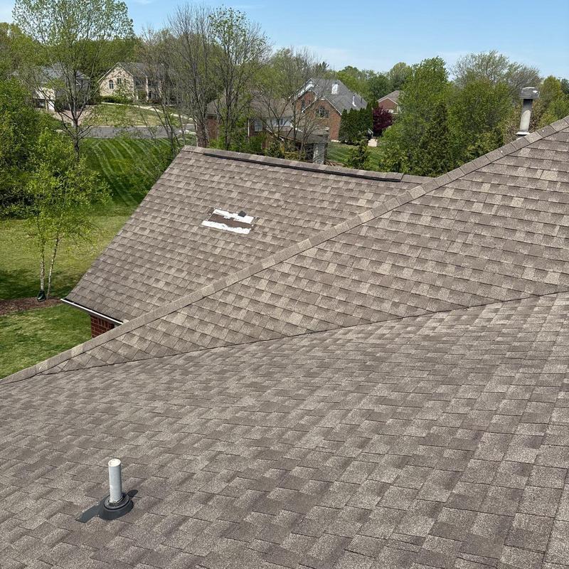 Asphalt shingle roof with hail damage and ventilation pipe