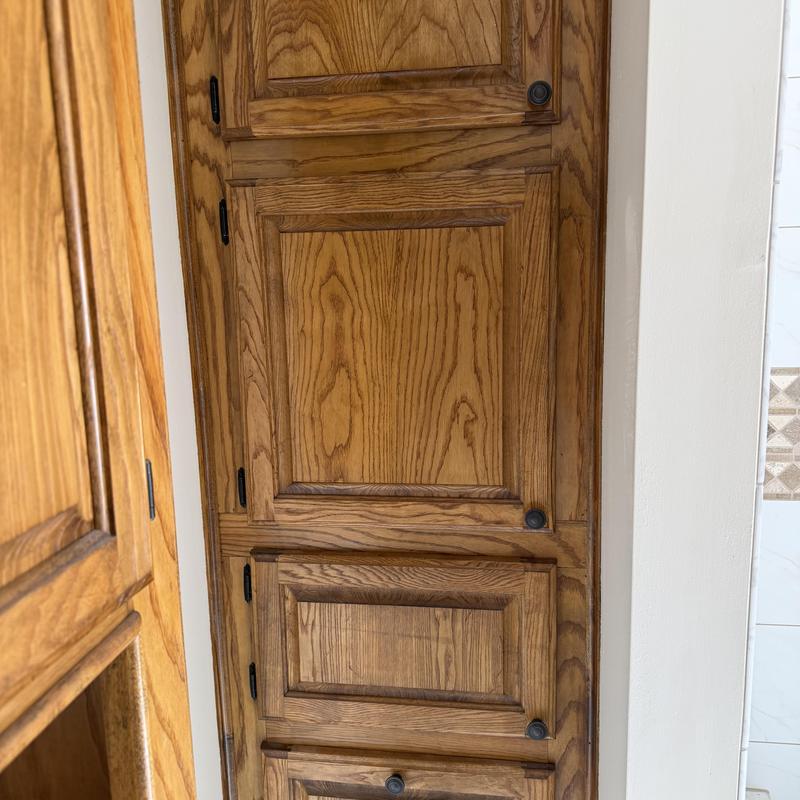 Cabinet doors with dark round hardware pulls installed