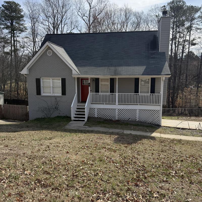 Siding damaged by woodpecker near chimney, repair needed