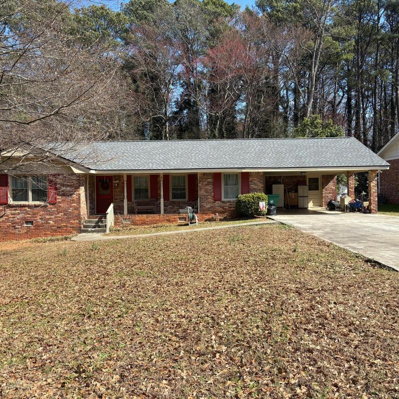 Seamless gutters and gutter helmets on brick house