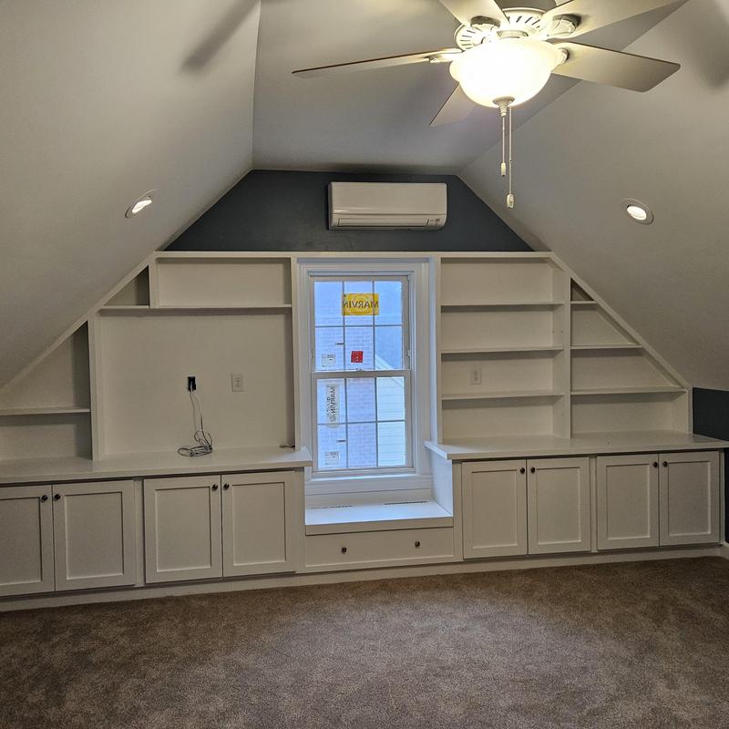 Built-in shelving and cabinetry in attic office space Built-in shelving and cabinetry in attic office space