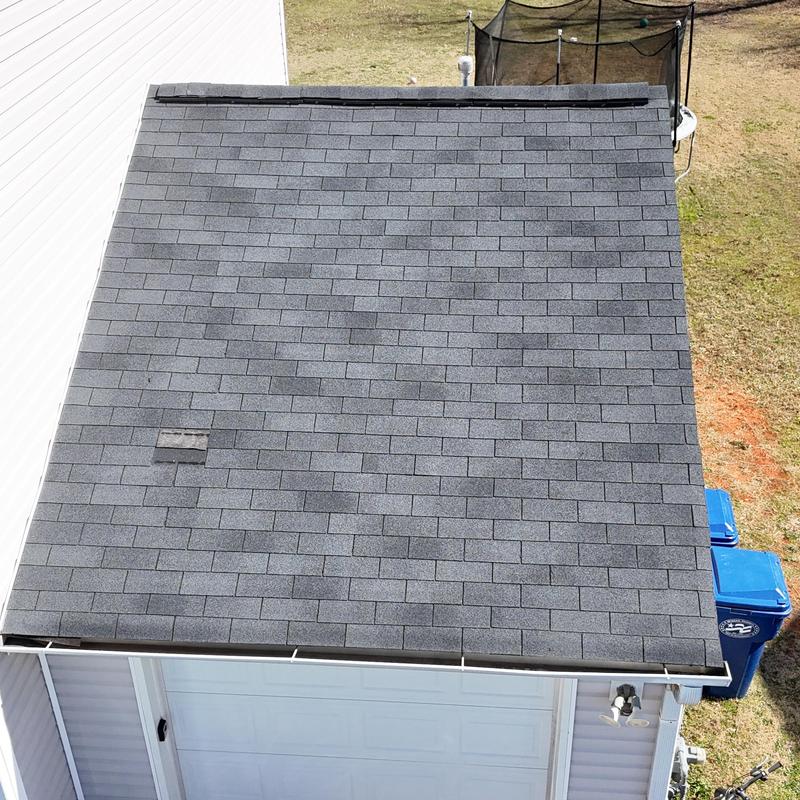 Slate shingle roof with one missing shingle near edge