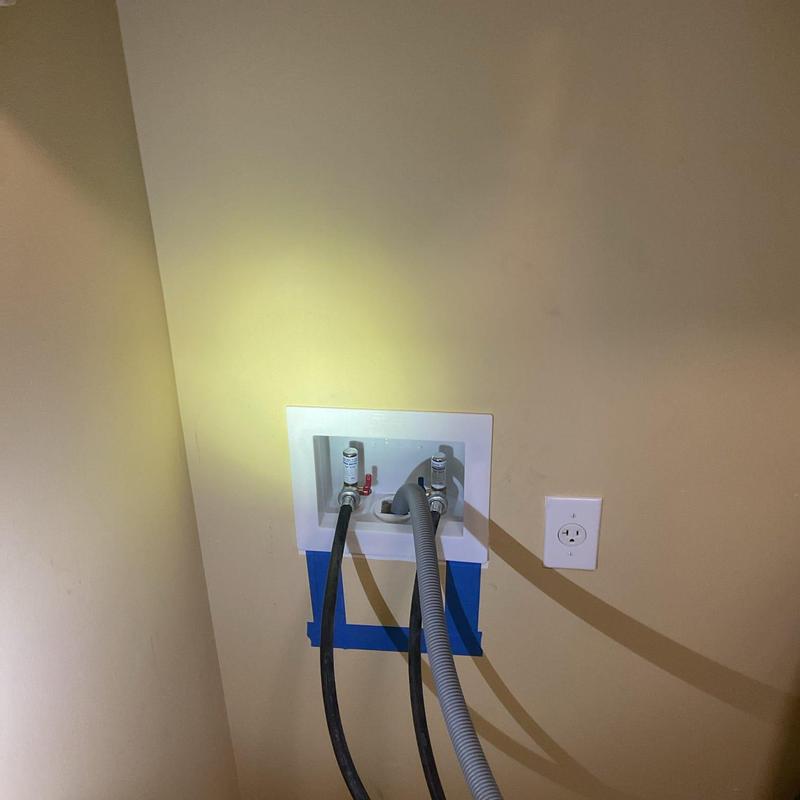 Washing machine box with valves and hoses installed