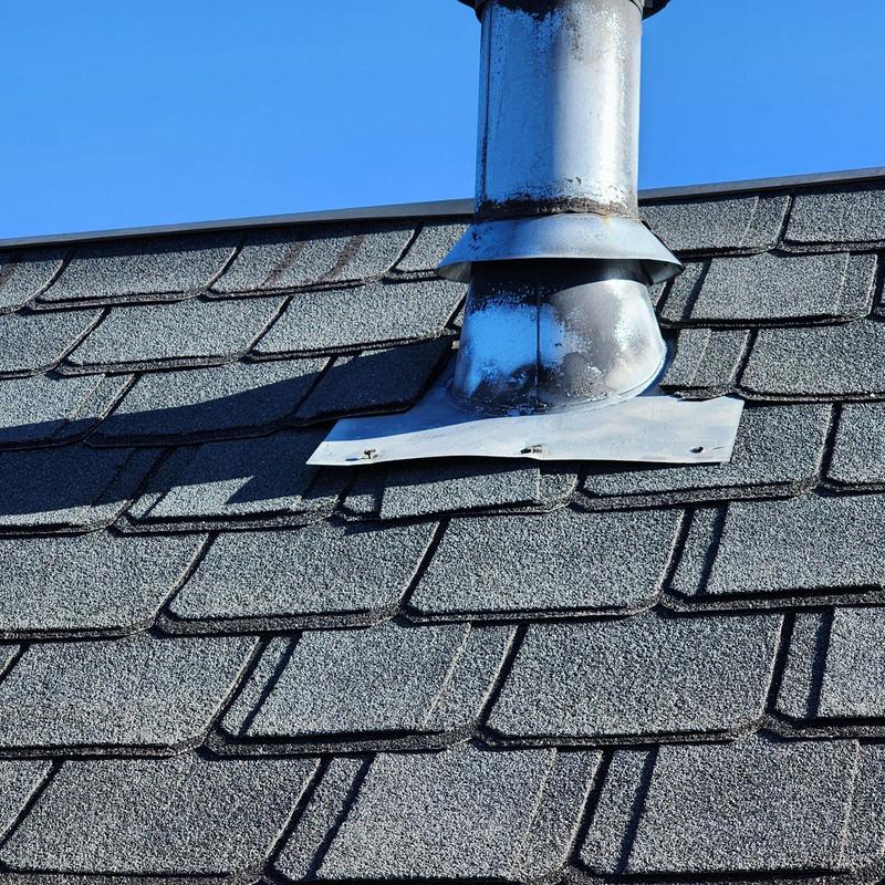 Metal pipe flashing on aged asphalt shingle roof Metal pipe flashing on aged asphalt shingle roof