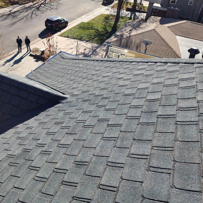 Asphalt shingle roof showing wear beneath eaves Asphalt shingle roof showing wear beneath eaves