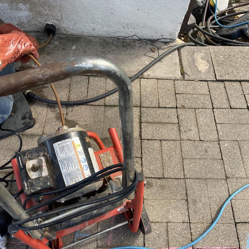Laundry drain cleaning machine in use outdoors