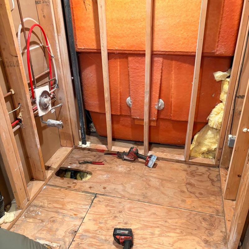 Bathtub plumbing and valve installation behind wall studs