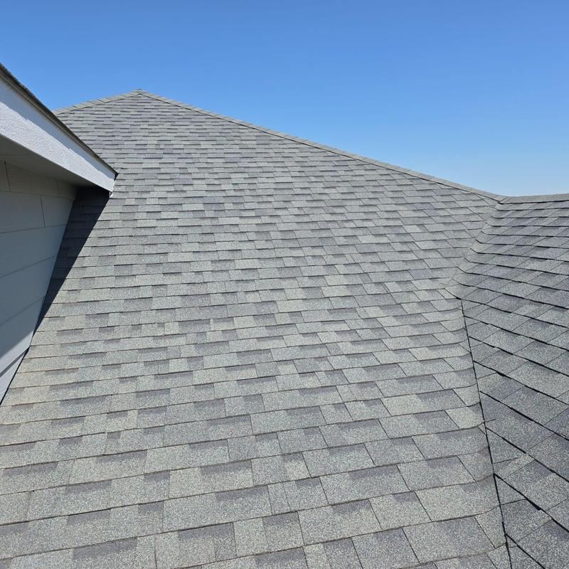 Shingle roof with hail damage inspection under clear sky Shingle roof with hail damage inspection under clear sky